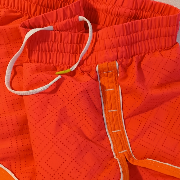 Heat Gear semi fitted size XS coral with orange line on the side - Picture 3 of 4